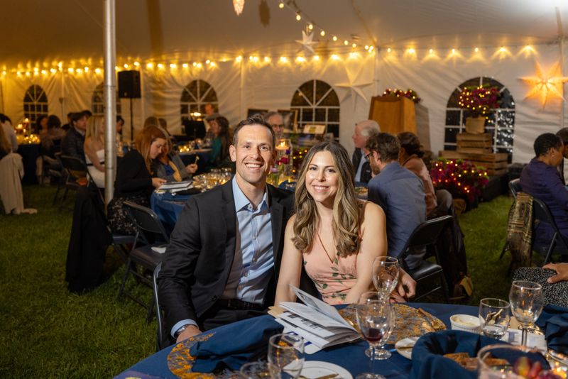 A couple enjoying the evening, posing for a photo at a Kimberton Waldorf School event.