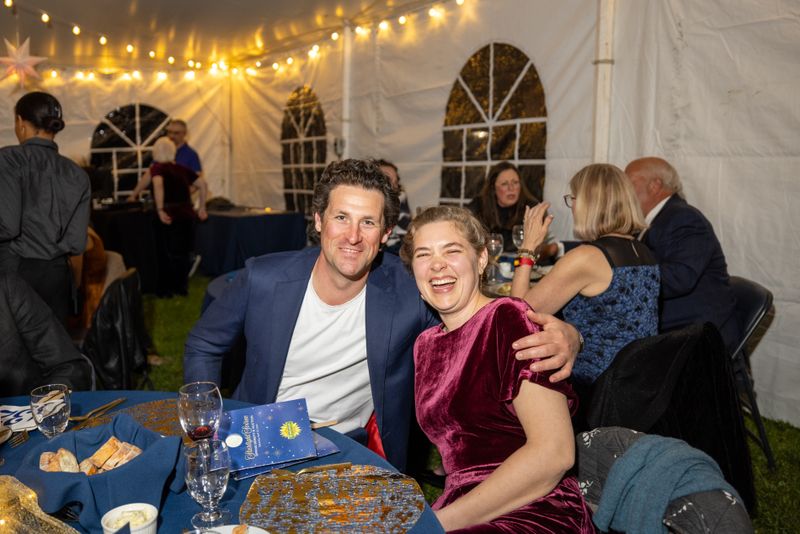 A couple enjoying the evening, posing for a photo at a Kimberton Waldorf School event.